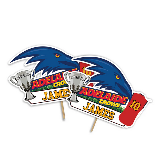 Adelaide Crows cake toppers with bold logo cutouts in team colors on flat lay white surface