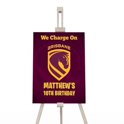 Brisbane Broncos welcome sign displaying a team greeting layout on a wooden display easel
