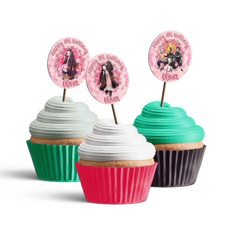 Demon Slayer Nezuko cupcake toppers with custom names and pink bamboo patterns arranged on frosted treats