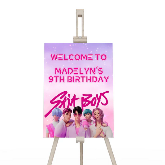 Huntrix - Saja Boys welcome sign with blue themed party design displayed on easel