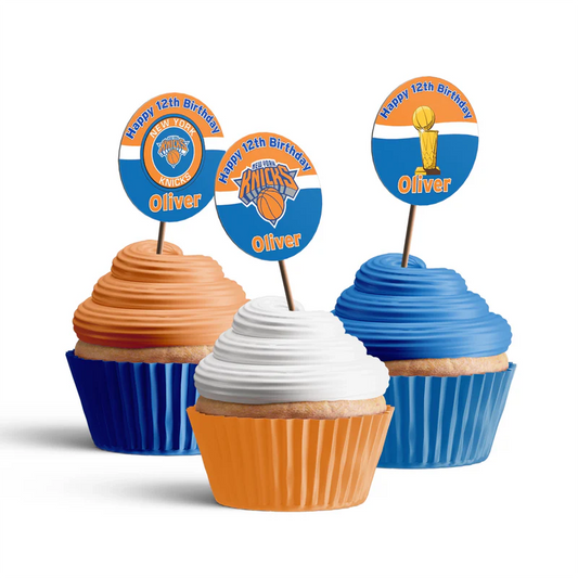 New York Knicks cupcake toppers with orange and blue basketball theme placed on frosted cupcakes