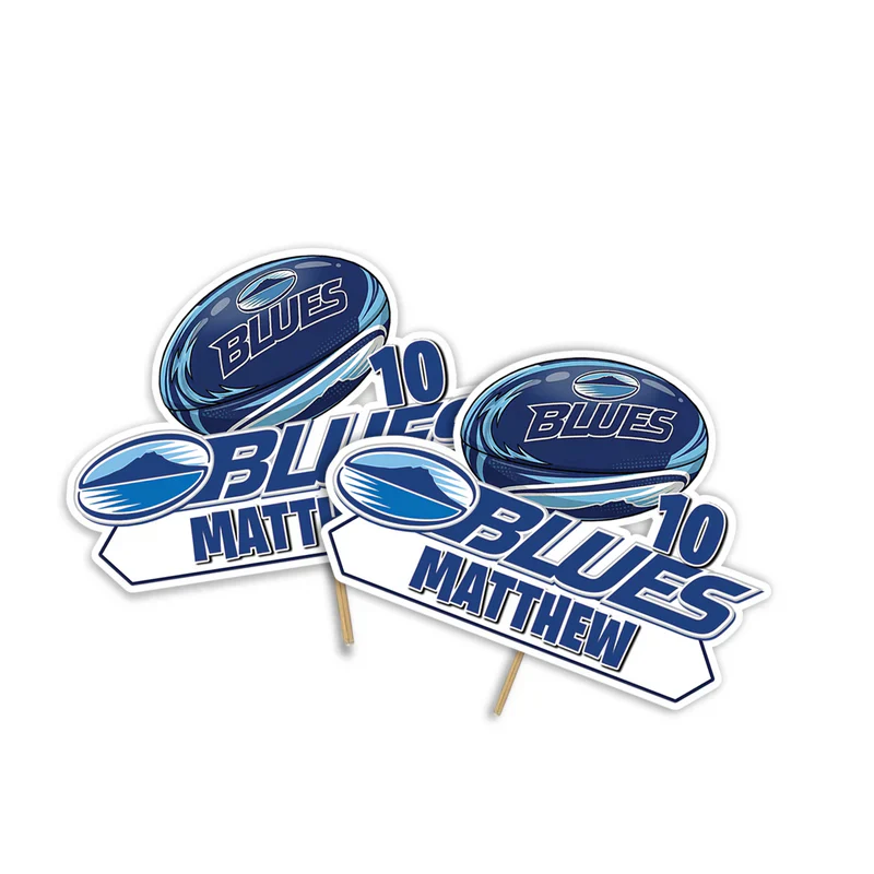 The Blues Rugby personalized cake toppers with custom text and a rugby ball cutout design on a clean white background.