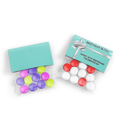 Tiffany & CO treat bag topper label with white ribbon graphics and custom name on a teal blue flat lay